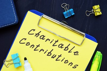 Business concept about Charitable Contributions with sign on the page.