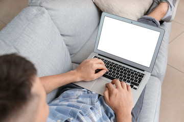 Naklejka premium Handsome man with laptop at home