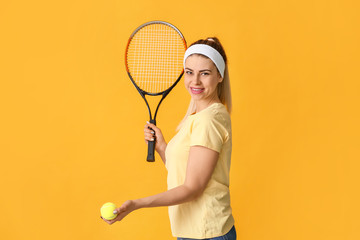 Portrait of beautiful tennis player on color background