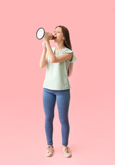 Emotional young woman with megaphone on color background