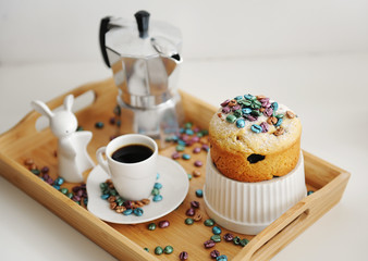 Easter still life. Coffee and cake. Espresso maker moka pot. White dishes, ceramic easter bunny. Colored coffee beans