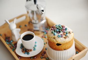 Easter still life. Coffee and cake. Espresso maker moka pot. White dishes, ceramic easter bunny. Colored coffee beans