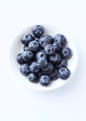 Bilberries isolated on white background. Concept for healthy nutrition. Top view. Copy space.