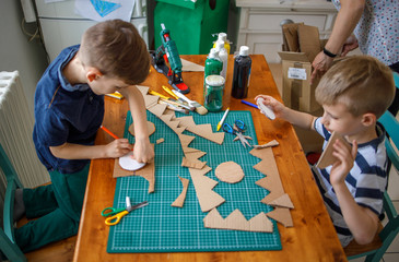 Boys making  cardboard costume