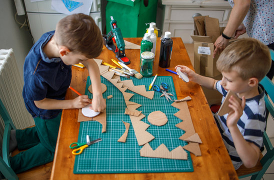Boys making  cardboard costume