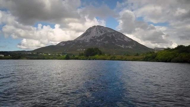 Aerial of  Mount Errigal in Donegal, Ireland.  Rising approach shot of mountain from the water.