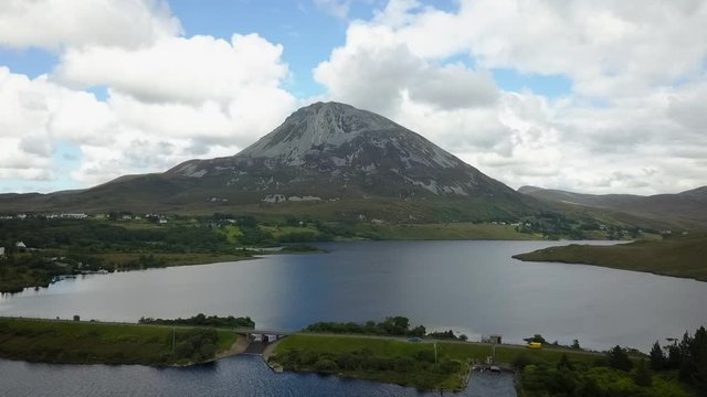 Aerial of Mount Errigal.  Donegal, Ireland. Orbit with white clouds and blue sky.