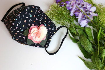 Handmade cotton face mask protective against dust and virus top view. Coronavirus cloth face mask.  DIY concept.