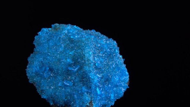 Blue Covelline or Covellite Crystals slowly rotates on a black background. Copper sulfide (CuS), from Etna volcano. Mineral of volcanic origin