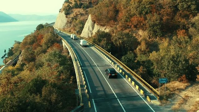 Road traffic on the bridge near the Danube. Autumn colors. Aerial view