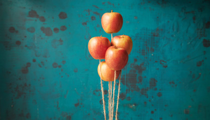 Bunch of floating apples against blue background