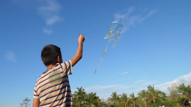 Rural Asian Boy Flying Kite 

