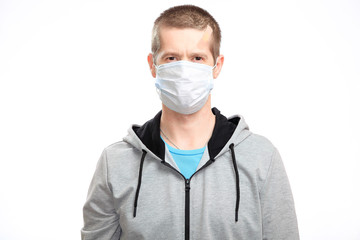 A sports confident wounded man with a medical mask and a Band-Aid on his head from the injury, sportswear, smiling, looking at the camera. Isolated