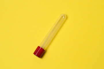 One blood collection tube on a yellow background