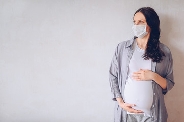 Sad pregnant woman wearing medical face masks due to illness, dizziness against infectious diseases...
