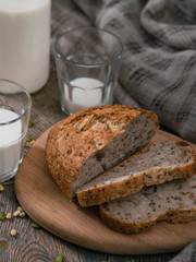 Rustic breakfast with milk and bread. World Milk Day on the first of June. Vertical shot from above.