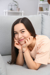 Portrait of beautiful young woman resting at home