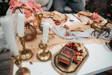 Wedding rings and bouquet of tulips on a white table.