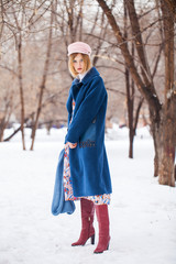 Portrait of a young beautiful woman in winter park