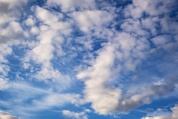 Blue sky background with big tiny stratus cirrus striped cloud before storm.