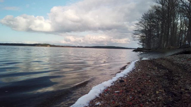 Closeup Lakeshore In The Evening. Slide Motion Along Shore Of Lake In Perspective In Low Angle.