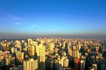 Fototapeta premium Panoramic view sunrise in the city life scene with blue sky above skycrapers. Great landscape.