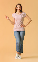 Young woman in stylish t-shirt on color background