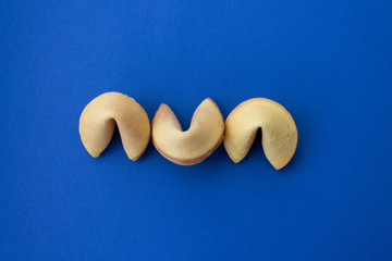 The fortune cookies on classic blue background. Flat lay style