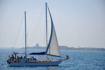 Fototapeta na wymiar Excursion on a sailing ship with tourists on the Black sea