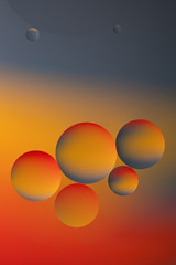 Abstract view of oil drops in water and coloured paper