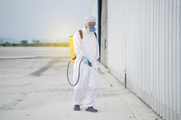 Specialist man in hazmat suits cleaning disinfecting coronavirus cells epidemic. Decontamination...