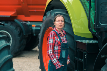 Fototapeta na wymiar Female farmer and agricultural tractor