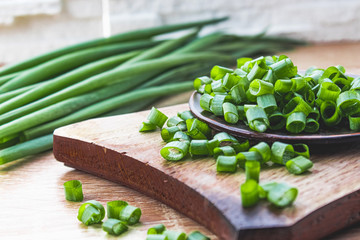 Sliced green onion rings in a bowl on the table.