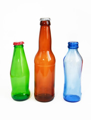 blue, green, brown glass beverage bottle on white background