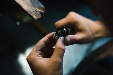 Master of jewelry while working on making a gold ring. Top view. 