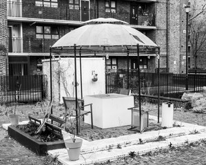The community garden. 
Black and white picture who depicts an empty and dilapidated community garden of London.