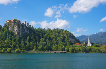 Sunny spring morning at Lake Bled and old medieval castle on the rock, famous tourist attraction in Slovenia