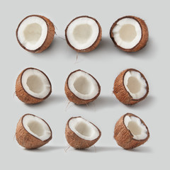 Fresh ripe tropical coconut fruits pattern on a light grey background