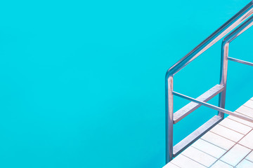 Outdoor swimming pool water and aluminum ladder