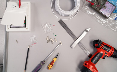 Top view work tools and electrical equipment on a desk