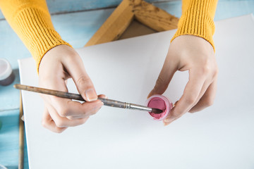 woman hand brush and gouache