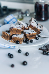 blackcurrant chocolate cake is sprinkled with powdered sugar