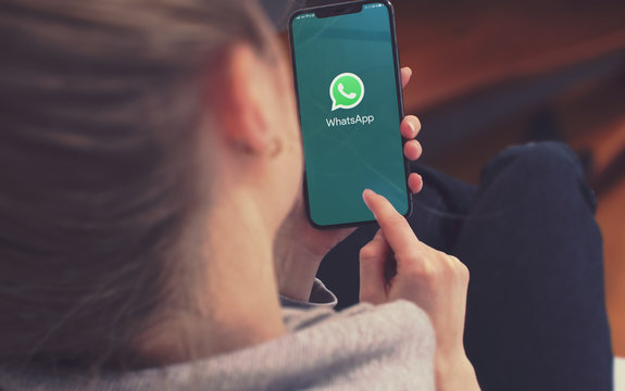 KYIV, UKRAINE-JANUARY, 2020: Whatsapp on Smart Phone Screen. Young Girl Pointing or Texting in Whatsapp on Mobile Phone During a Pandemic Self-Isolation and Coronavirus Prevention.