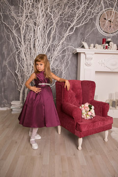 A little girl dressed elegantly played princess
