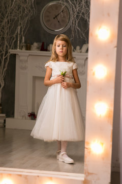 A little girl dressed elegantly played princess