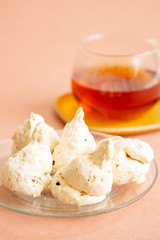Homemade baked meringue cakes on the pink background