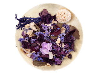 Potpourri in an old gold colour bowl, isolated on white background. Purple, mauve shades. Seen from...