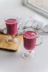 delicious berry smoothie on a wooden Board on a light background