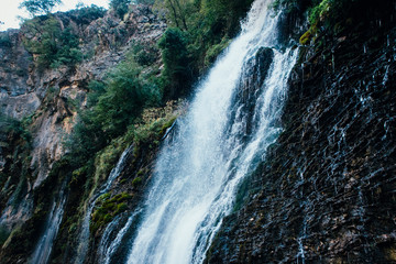Fototapeta premium Beautiful high waterfall Kapuzbasi in Turkey, stone mountain blue stream water
