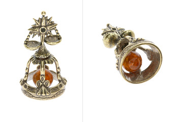 Amber souvenir. A miniature metal bell in the form of a zodiac sign 
